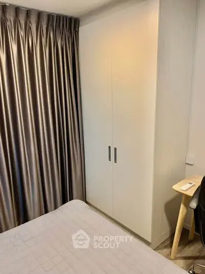 Cozy bedroom with modern wardrobe and elegant curtains