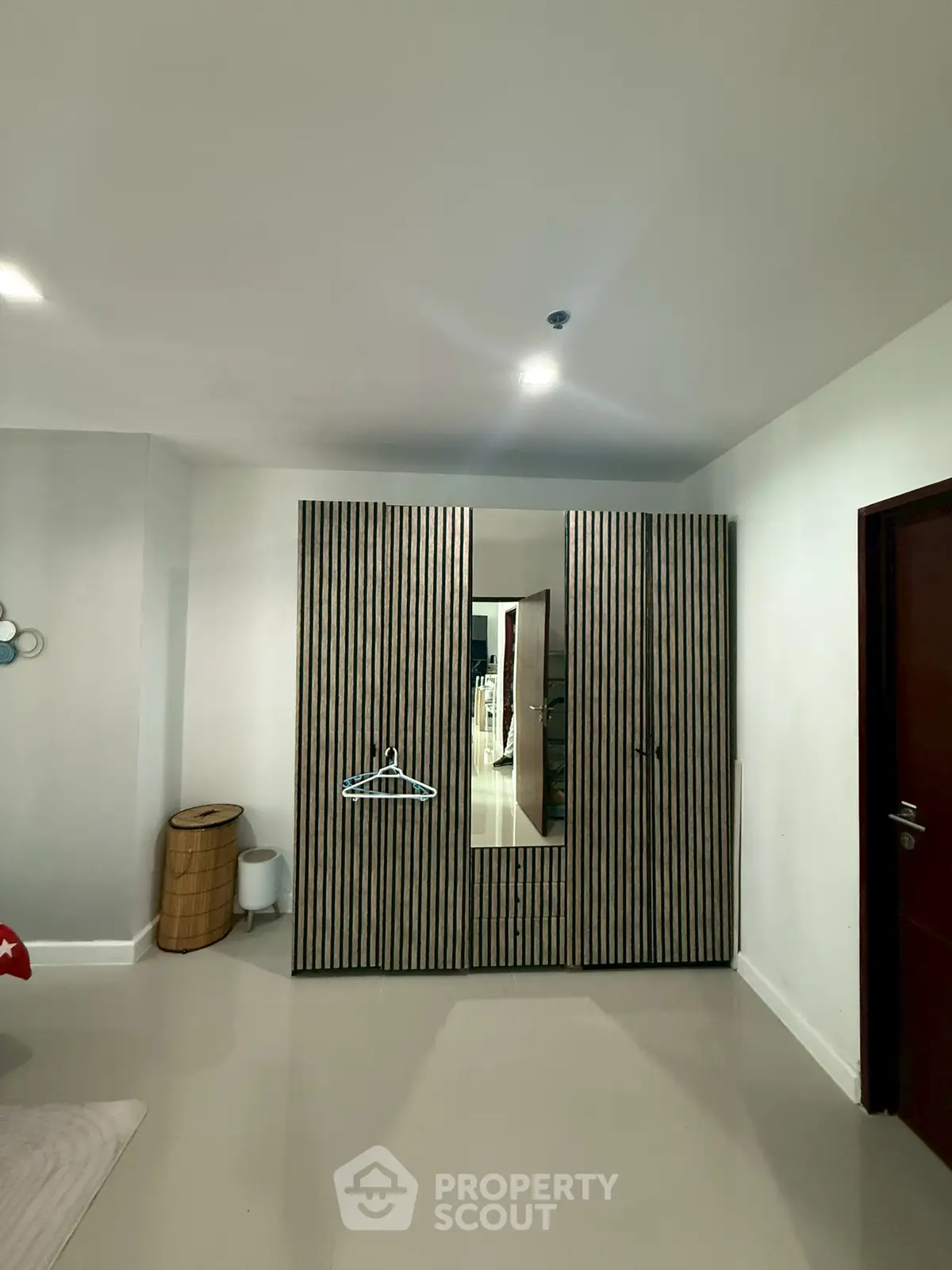 Modern bedroom with sleek wardrobe and minimalist decor