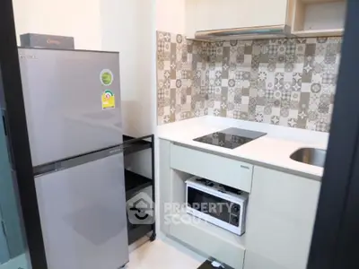Modern kitchen with sleek appliances and stylish backsplash