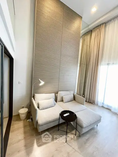 Modern living room with high ceiling and stylish furniture