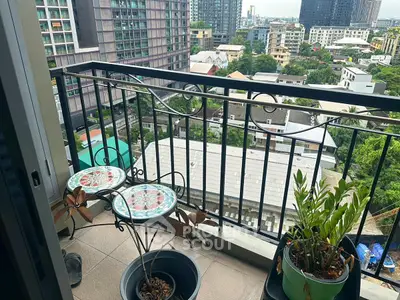 Charming balcony with city view and decorative furniture in urban setting.