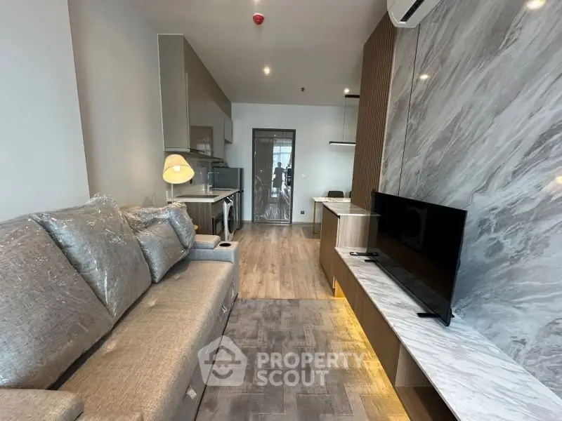 Modern living room with stylish decor and open kitchen layout in a contemporary apartment.