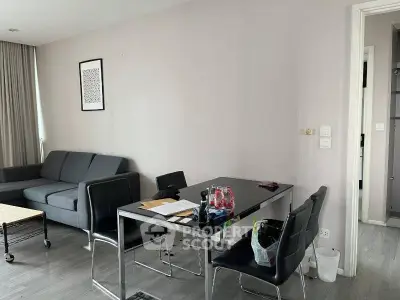 Modern living room with sleek furniture and dining area, perfect for urban living.