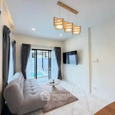 Modern living room with pool view, featuring stylish lighting and cozy seating.