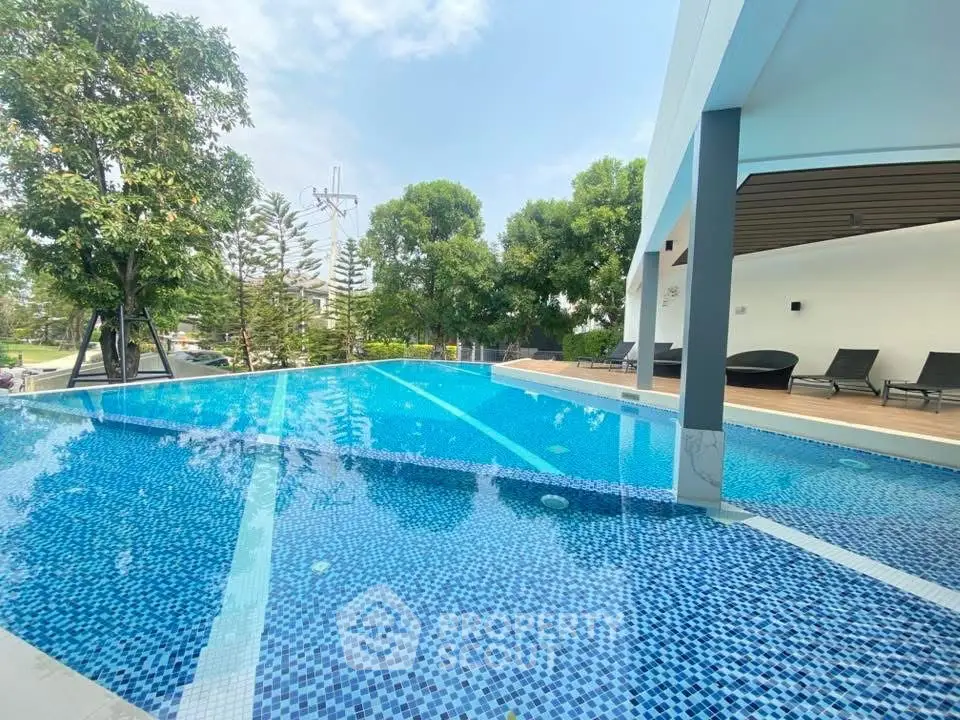 Luxurious infinity pool with modern design and lush greenery, perfect for relaxation and leisure.