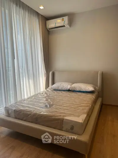 Modern bedroom with elegant bed and natural light from large window