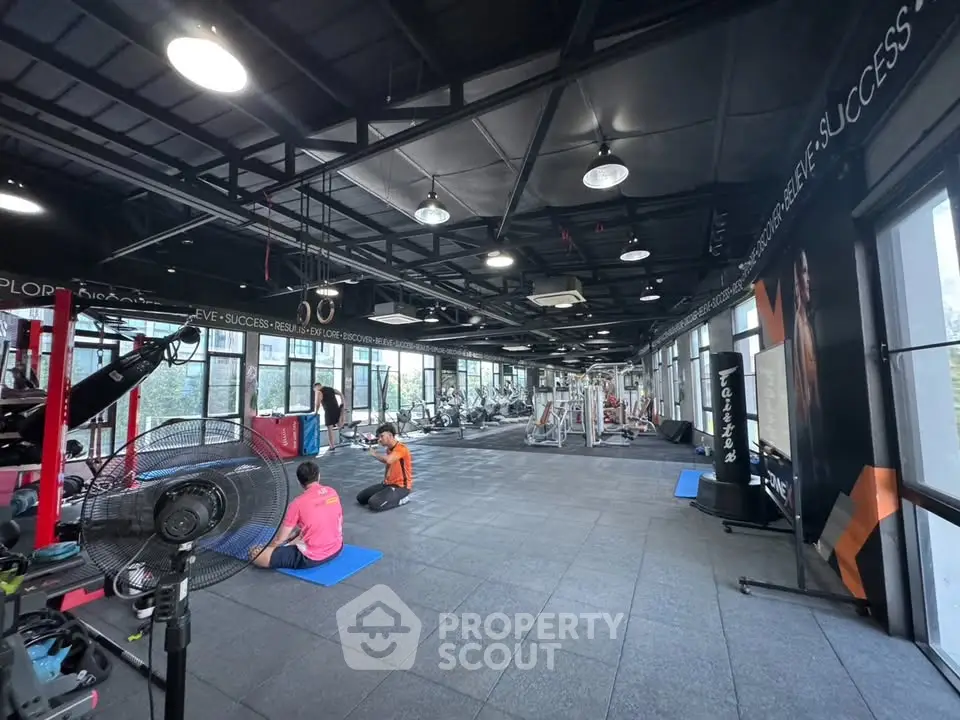 Spacious modern gym with large windows and fitness equipment, ideal for active lifestyle enthusiasts.