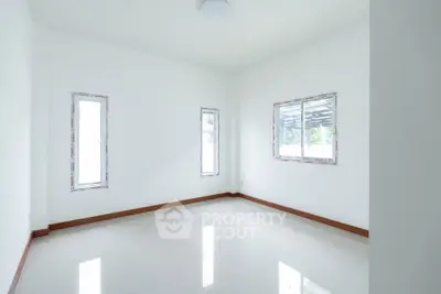 Bright empty room with large windows and glossy floor tiles