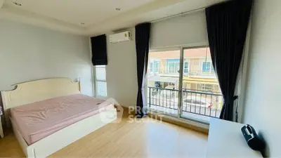 Spacious bedroom with balcony view in modern apartment