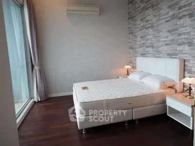 Modern bedroom with stylish decor and large window for natural light