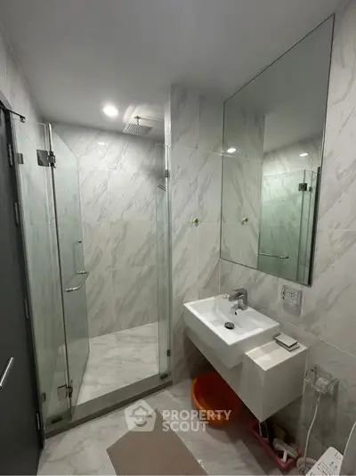 Modern bathroom with glass shower and sleek sink design