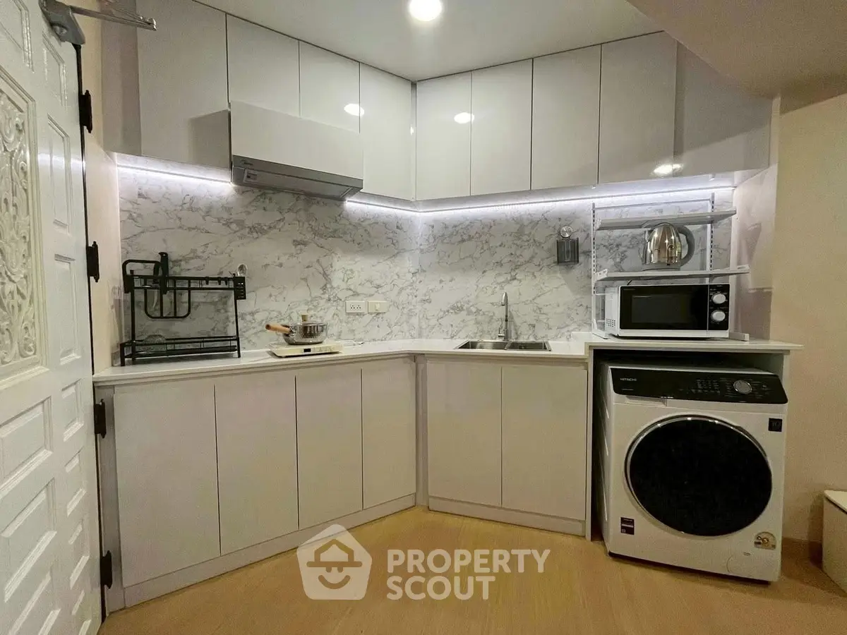Modern kitchen with sleek cabinets and built-in appliances