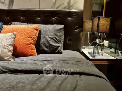 Luxurious bedroom with elegant bedding and stylish bedside lamp