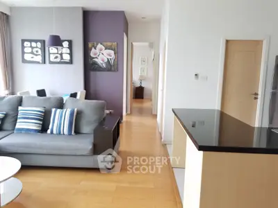 Spacious modern living room with stylish decor and open layout, featuring a cozy sofa and elegant dining area.