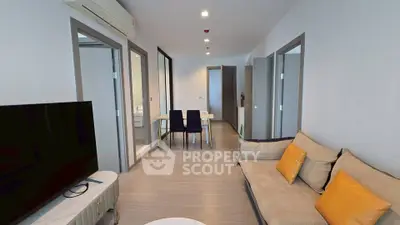 Modern living room with cozy sofa and dining area in a stylish apartment.