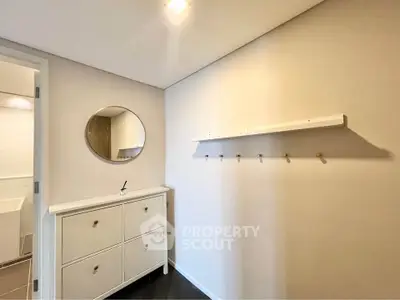 Modern minimalist bathroom with sleek vanity and round mirror