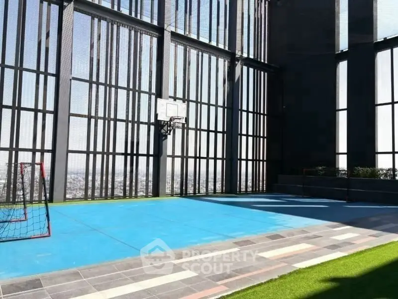 Modern rooftop sports court with city views and high-rise fencing.