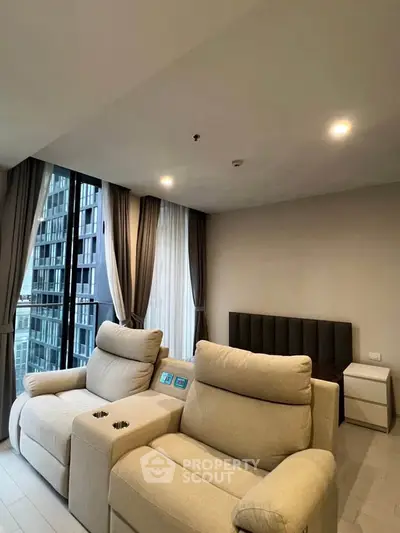 Modern living room with plush seating and large windows in a high-rise apartment.