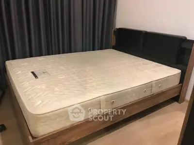Spacious bedroom with modern bed frame and comfortable mattress