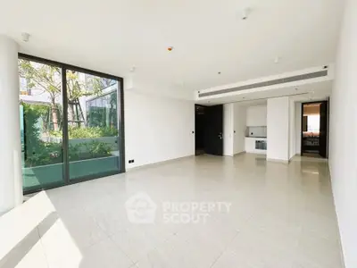 Spacious modern living room with large windows and garden view in luxury apartment.