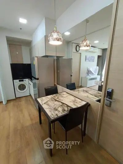 Modern kitchen with marble dining table and appliances in stylish apartment