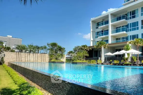 Luxurious apartment complex with stunning pool and modern architecture.