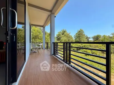 Spacious balcony with scenic forest view, perfect for relaxation and outdoor dining.
