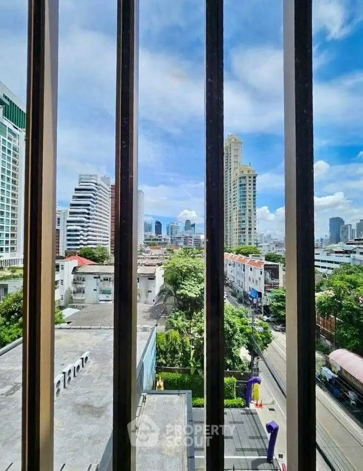 Stunning urban view from high-rise building with city skyline and blue sky.