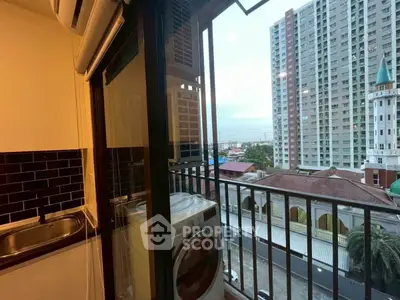 Charming apartment balcony with city view and laundry area, perfect for urban living.