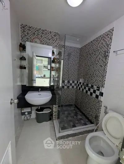 Modern bathroom with glass shower and stylish tile design