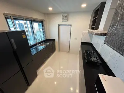 Modern kitchen with sleek black appliances and open layout design