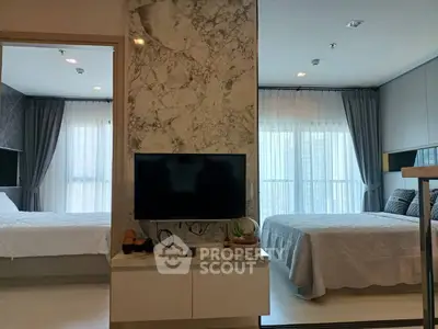 Modern dual-bedroom apartment with stylish decor and natural light