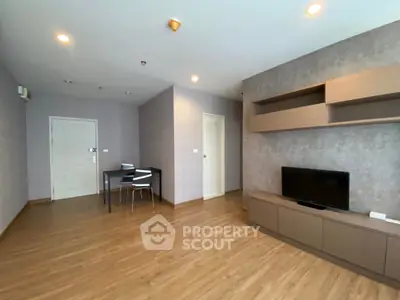 Spacious modern living room with wooden flooring and built-in TV unit