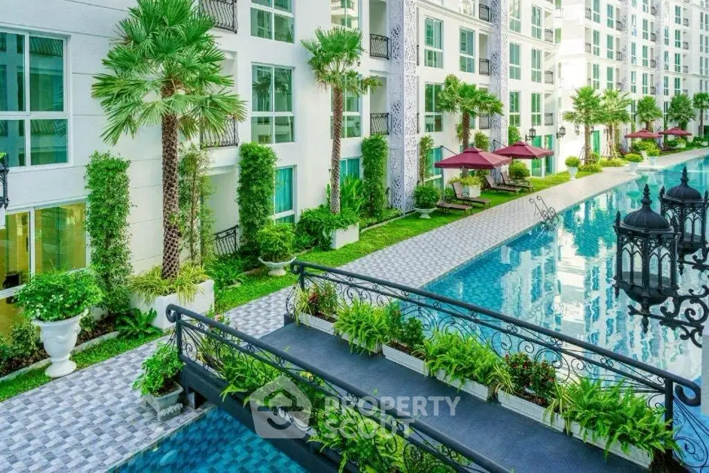 Luxurious condominium with stunning pool and lush garden view