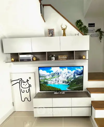 Modern living room with stylish TV setup and decorative shelving