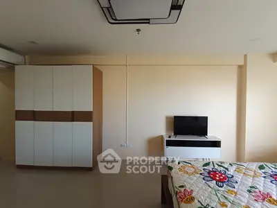 Spacious bedroom with modern wardrobe and TV unit, perfect for comfortable living.