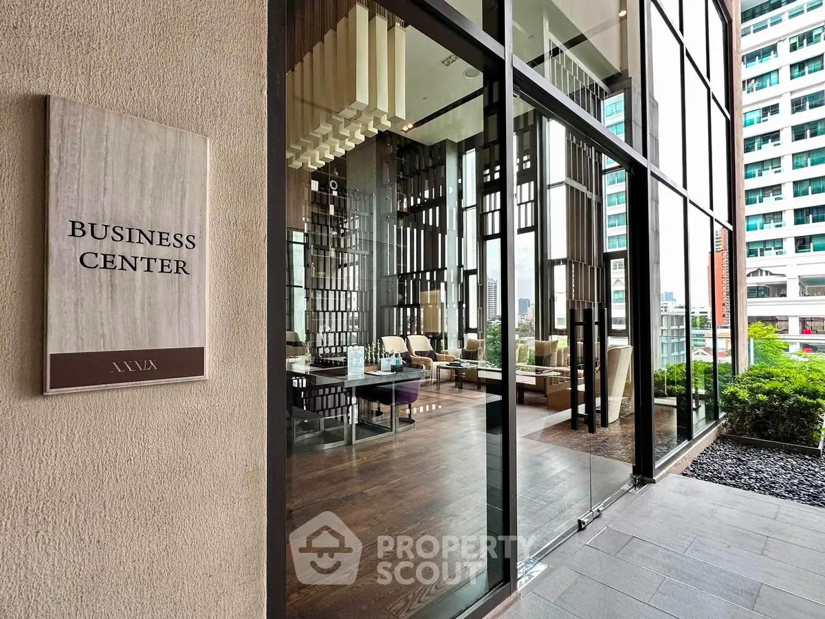 Modern business center entrance with glass facade and stylish interior design.