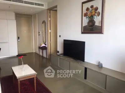 Modern living room with sleek TV unit, elegant decor, and stylish furniture in a contemporary apartment.