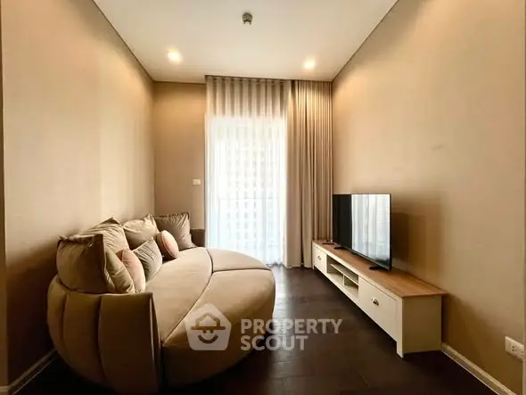 Cozy living room with modern sofa and TV unit, perfect for relaxation.