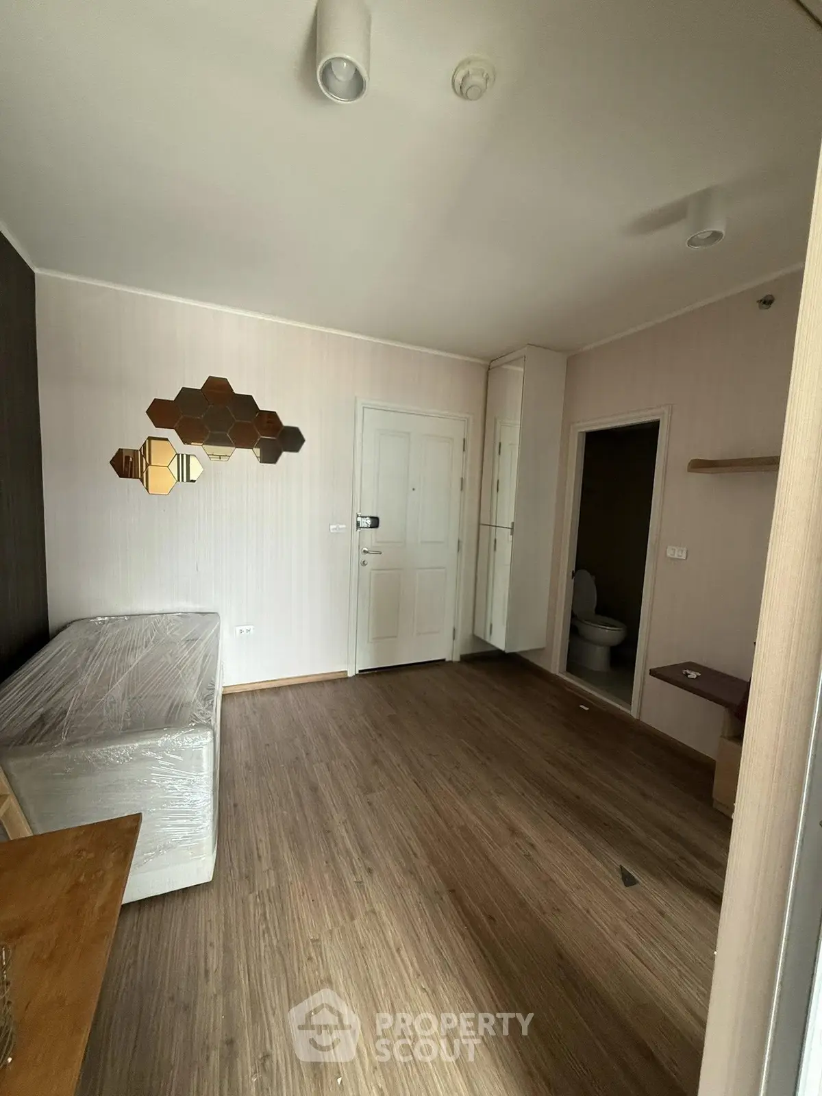 Modern apartment interior with wooden flooring and stylish wall decor