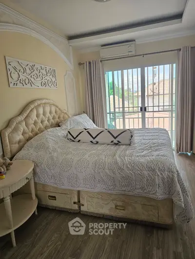 Luxurious bedroom with elegant decor and large window offering a serene view, perfect for relaxation.