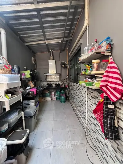 Compact kitchen with open layout and gas stove, featuring efficient storage solutions and modern design.