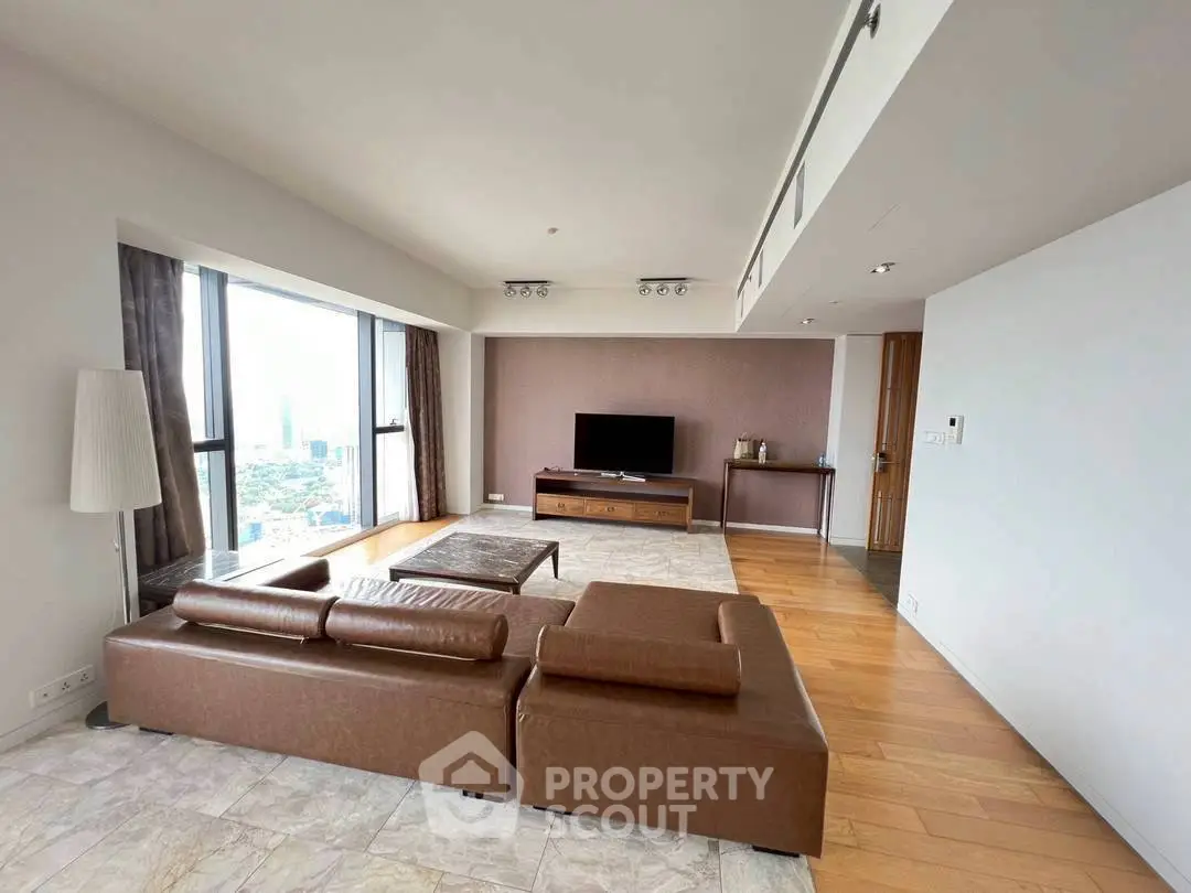 Spacious living room with panoramic city view and modern leather sofa