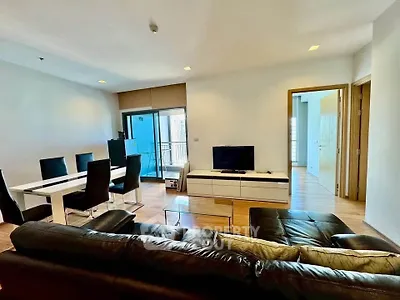 Spacious modern living room with sleek furniture and balcony access