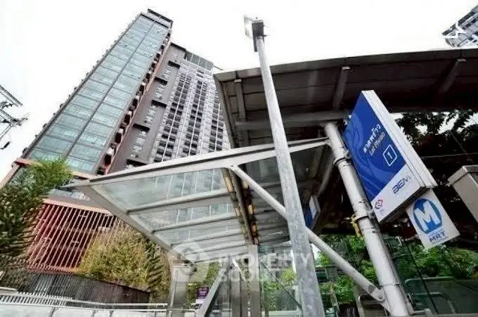 Modern high-rise building near public transportation station with urban convenience.