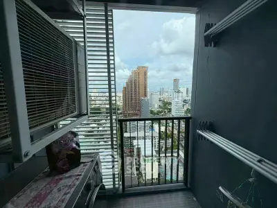 High-rise balcony with stunning cityscape view and modern railing.