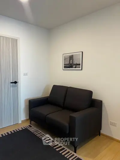 Cozy living room with modern black sofa and stylish decor