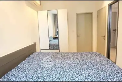Cozy bedroom with mirrored wardrobe and stylish bedding in modern apartment.