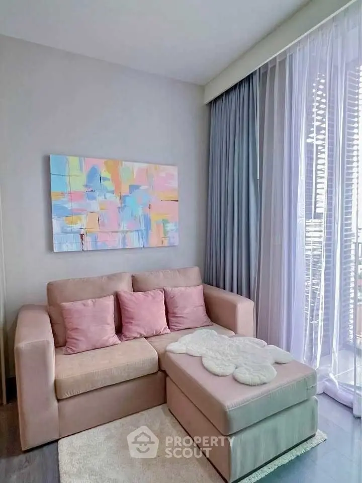 Cozy living room with pastel decor and modern art, perfect for relaxation.