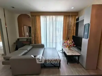 Modern living room with stylish sofa and large window in a contemporary apartment.